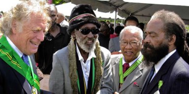From left; Island Records founder Chris Blackwell speaks with Noel Simms; Ernie Ranglin and John Holt after receiving the Order of Jamaica, the country's fourth-highest honor, at the National Honors and Awards ceremony in Kingston, Jamaica, Monday, Oct. 18,2004.