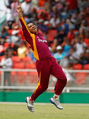 West Indies' Sunil Narine celebrates after bowling out Australia batsman for 2 runs during their third one day international cricket match in Kingstown, St. Vincent, Tuesday March 20,2012.