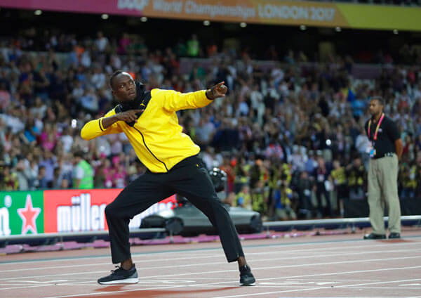 Jamaica's Usain Bolt makes his trademark gesture during a lap of honor at the end of the World Athletics Championships in London Sunday, Aug. 13, 2017.
