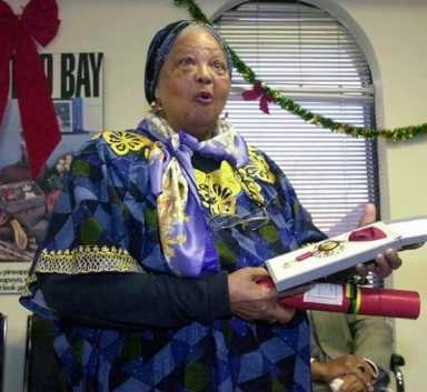 Louise Bennett-Coverley reacts as she is awarded the Order of Merit at the Jamaican Consulate in Toronto in this, Dec. 18; 2001 file photo.Bennett-Coverley died Wednesday, July 26, 2006. She was 86.