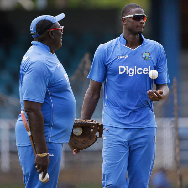 Former West Indies's bowling coach Roddy Estwick, left,talks to team captain Jason Holder during a practice at Queen's Park Oval in Port of Spain, Trinidad and Tobago, Thursday, June 22, 2017.