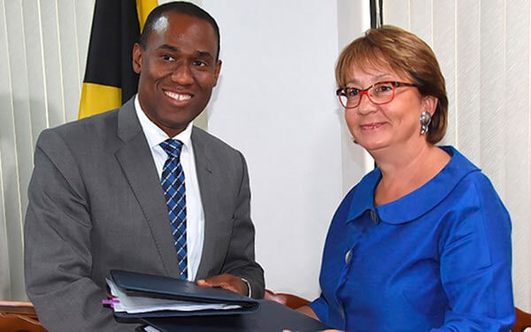 Dr. Nigel Clarke (left)Jamaica's minister of Finance, the Public Service and Galina Sotirova, World Bank country manager, exchange copies of a US$4.875 million agreement.