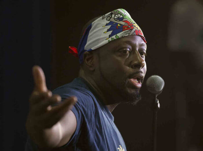 Haitian-American hip-hop star Wyclef Jean gestures as he speaks during a news conference at the Little Haiti Cultural Center in Miami.