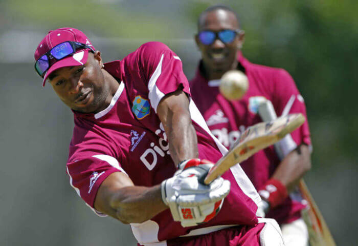 West Indies Kieron Pollard bats as his teammate Dwayne Bravo looks on during a practice session in Kingstown, St. Vincent.