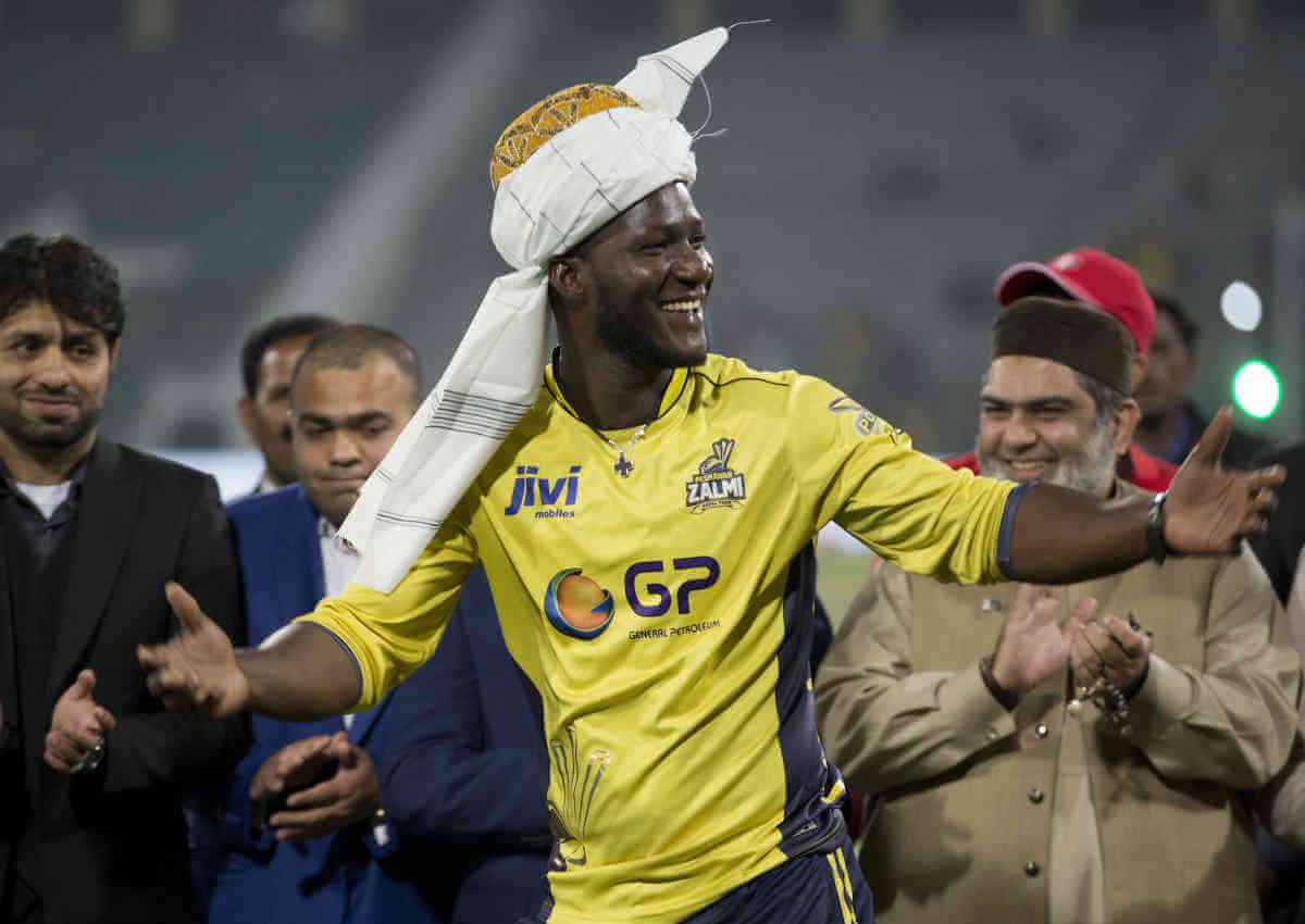 Former West Indies Captain Darren Sammy gestures wearing a traditional turban at Gaddafi Stadium in Lahore; Pakistan.