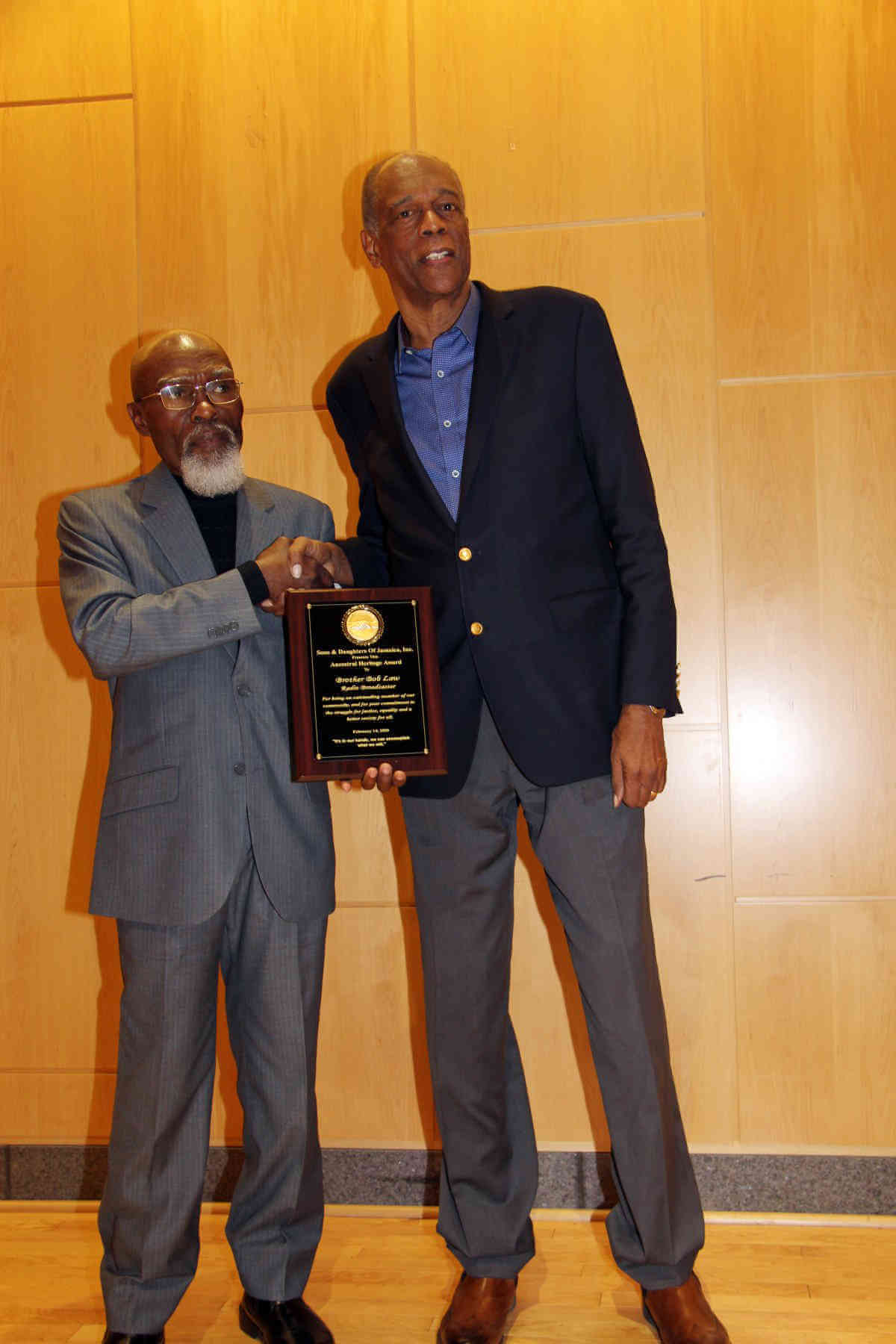 Moderator Jose Richards (left) presents plaque to Bob Law.