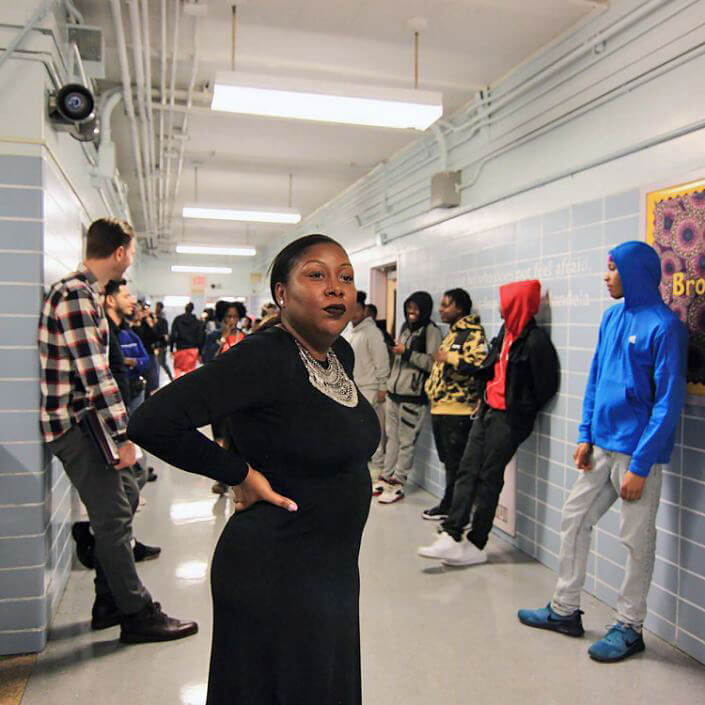 Dez-Ann Romain with students of her school. New York Times