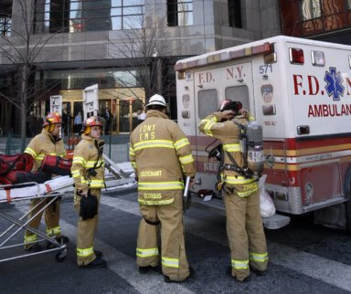 Members of the FDNY Emergency Medical Services unit enter the One World Financial Center building after a suspicious white powder substance was found in envelopes in the mailroom of the Wall Street Journal in in New York