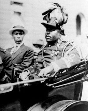 Black nationalist Marcus Garvey is shown in a military uniform as the 'Provisional President of Africa during a parades up Lenox Avenue in Harlem, New York City, Aug. 1922, during opening day exercises of the annual Convention of the Negro Peoples of the World.