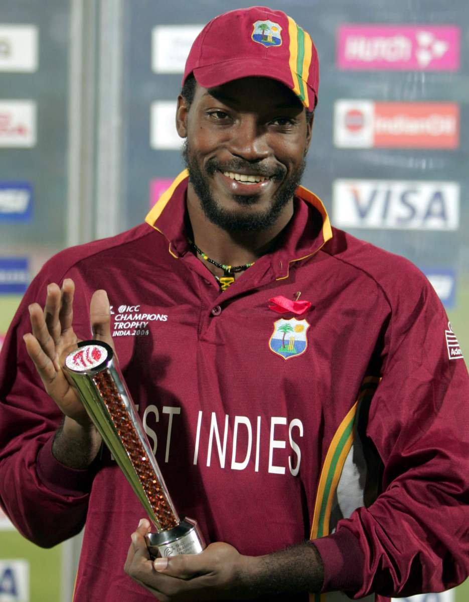 West Indies’ Gayle poses with the man of the match trophy after winning their semi-final match against South Africa in Jaipur