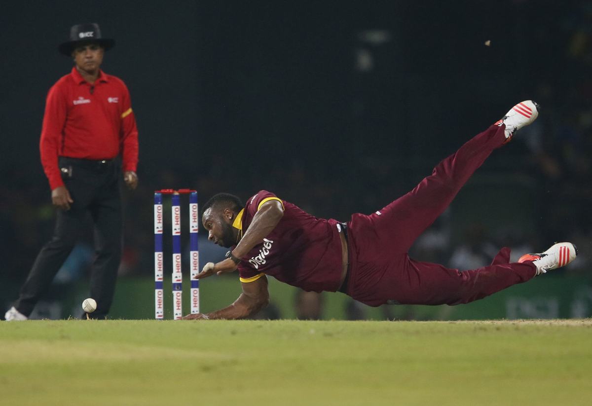 West Indies’ Pollard dives to stop the ball during their second Twenty 20 International cricket match against Sri Lanka in Colombo