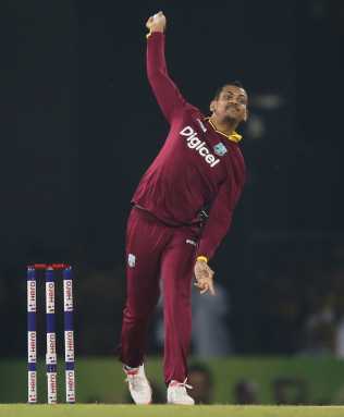 Narine bowls during their second Twenty 20 International cricket match against Sri Lanka in Colombo