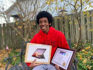 Michael Eldon Prass displays his certificate and prize. Prass Family