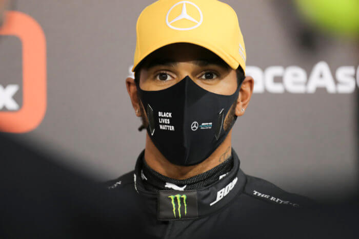 Mercedes driver Lewis Hamilton of Britain stands in the pit-lane after the qualifying at the Formula One Abu Dhabi Grand Prix in Abu Dhabi, United Arab Emirates, Saturday, Dec. 11, 2020. 