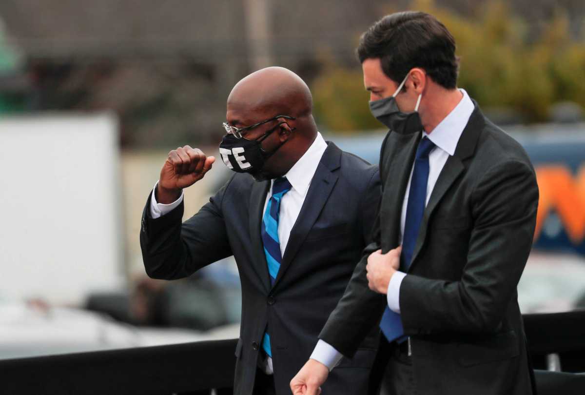 FILE PHOTO: Georgia Democratic U.S. Senate candidates Rev. Raphael Warnock at a drive-in campaign rally in Atlanta and Jon Ossoff