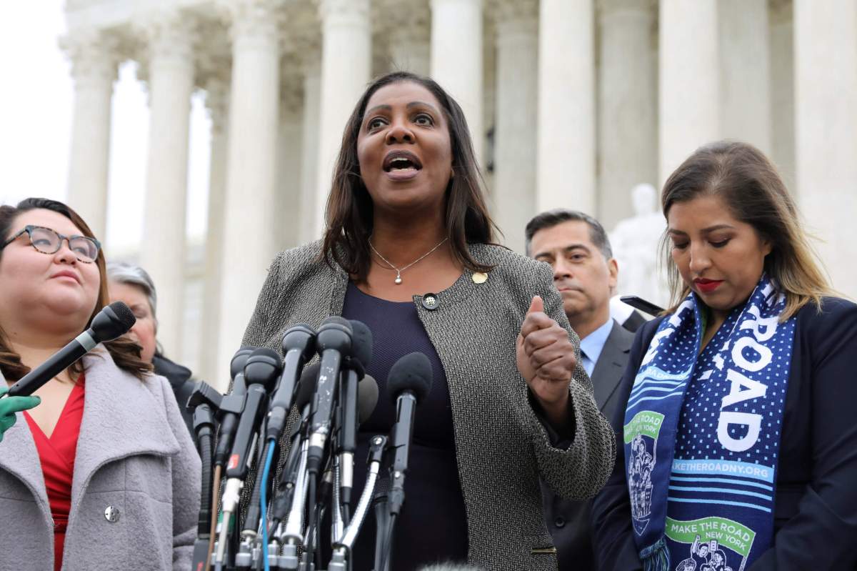 New York State Attorney General James, flanked by DACA plaintiffs Rosas and Fernandez, speaks to reporters outside the U.S. Supreme Court after oral arguments in cases regarding the Trump administration’s bid to end the DACA program in Washington