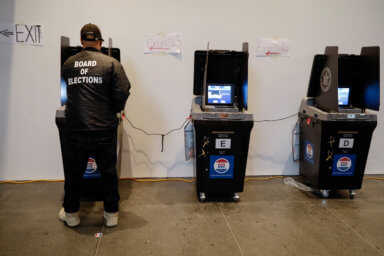 A Board of Elections employee cleans a voting machine during early voting at the Brooklyn Museum in Brooklyn, New York