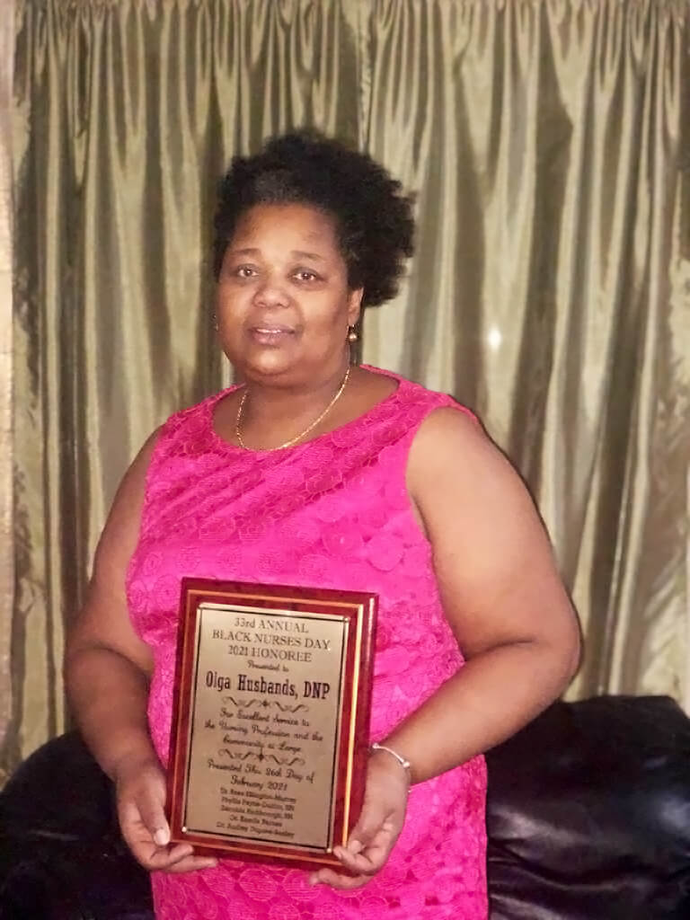 Dr. Olga Husbands with plaque.   Kyle Bailey