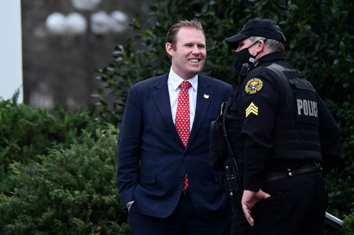 Andrew Giulian speaks to a Secret Service officer outside the West Wing of the White House in Washington