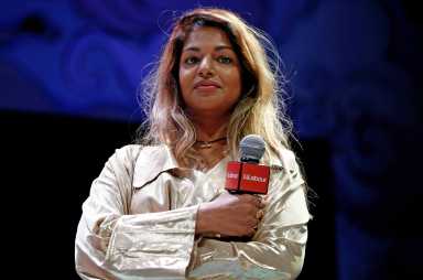 Singer M.I.A. stands on the stage at the Theatre Royal in London