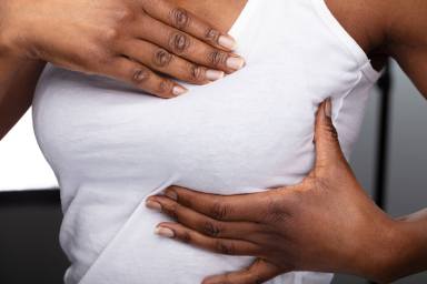 Close-up Of A Woman’s Hand On Breast