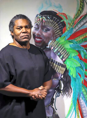 Trinidad-born artist, Weldon Ryan against one of his Carnival portraits that was on display from May 26, 2021 at the Stone Sparrow Gallery, 45 Greenwich Ave., Manhattan.