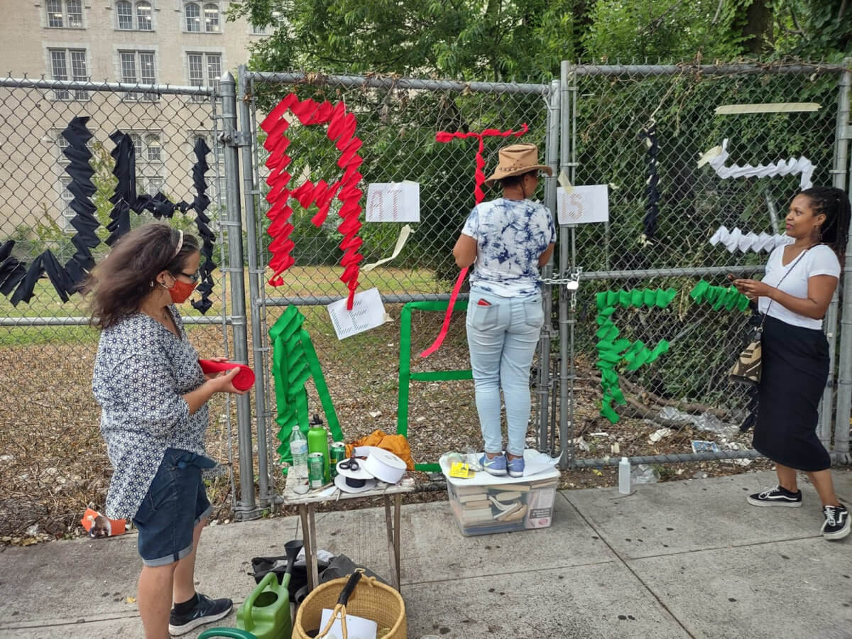 Members of the coalition weaving the fence.  Corazon Valiente