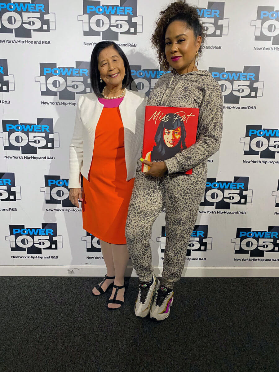 Miss Pat Chin with Angela Yee displaying a copy of “Miss. Pat.”