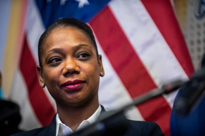 Keechant Sewell, the first black female NYPD commissioner, listens to Mayor-elect Eric Adams speak at the Queensbridge houses in Long Island City, Queens on Wednesday, Dec. 15, 2021, in New York. 