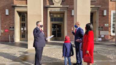 Richards takes the oath flanked by his wife and son