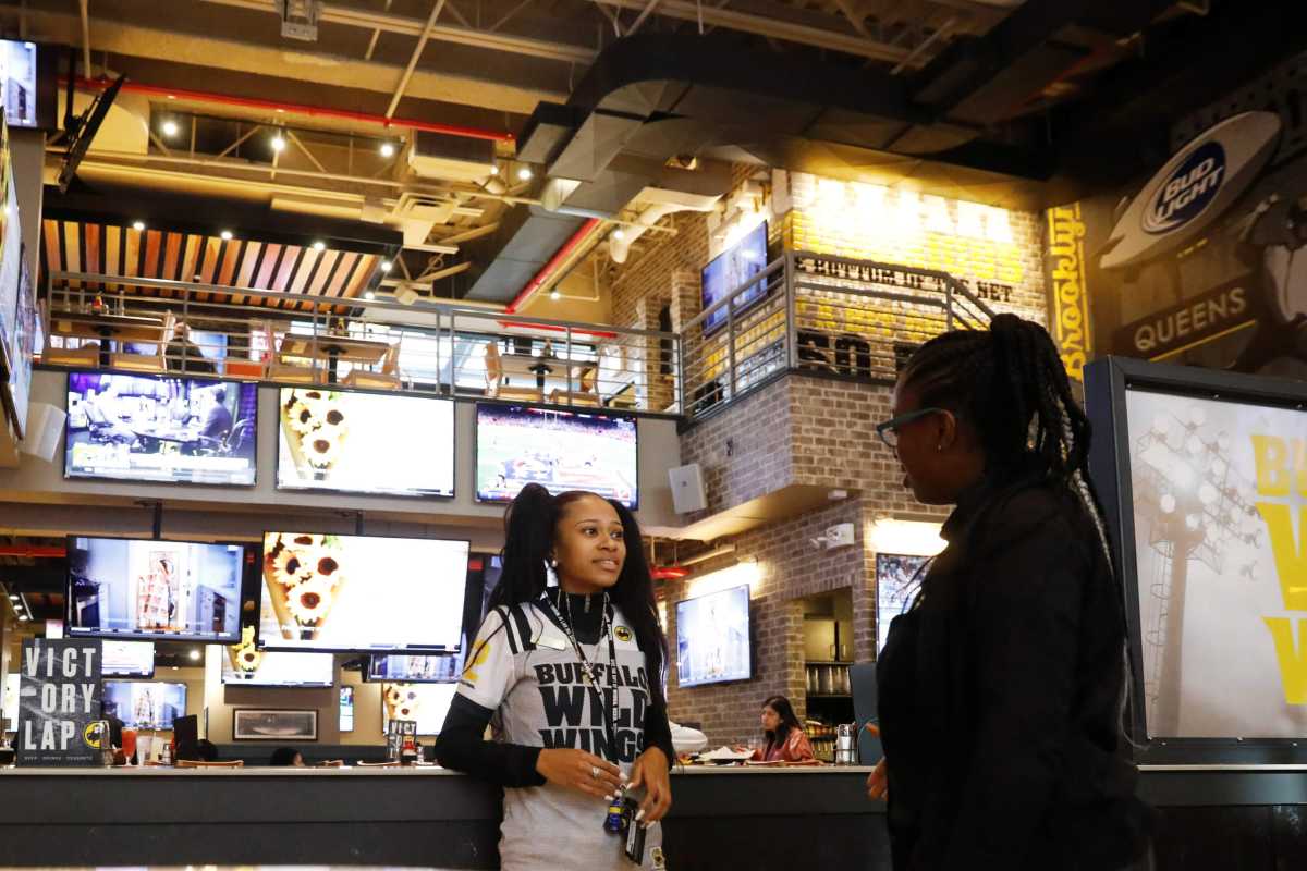 An employee works inside of a Buffalo Wild Wings restaurant in New York