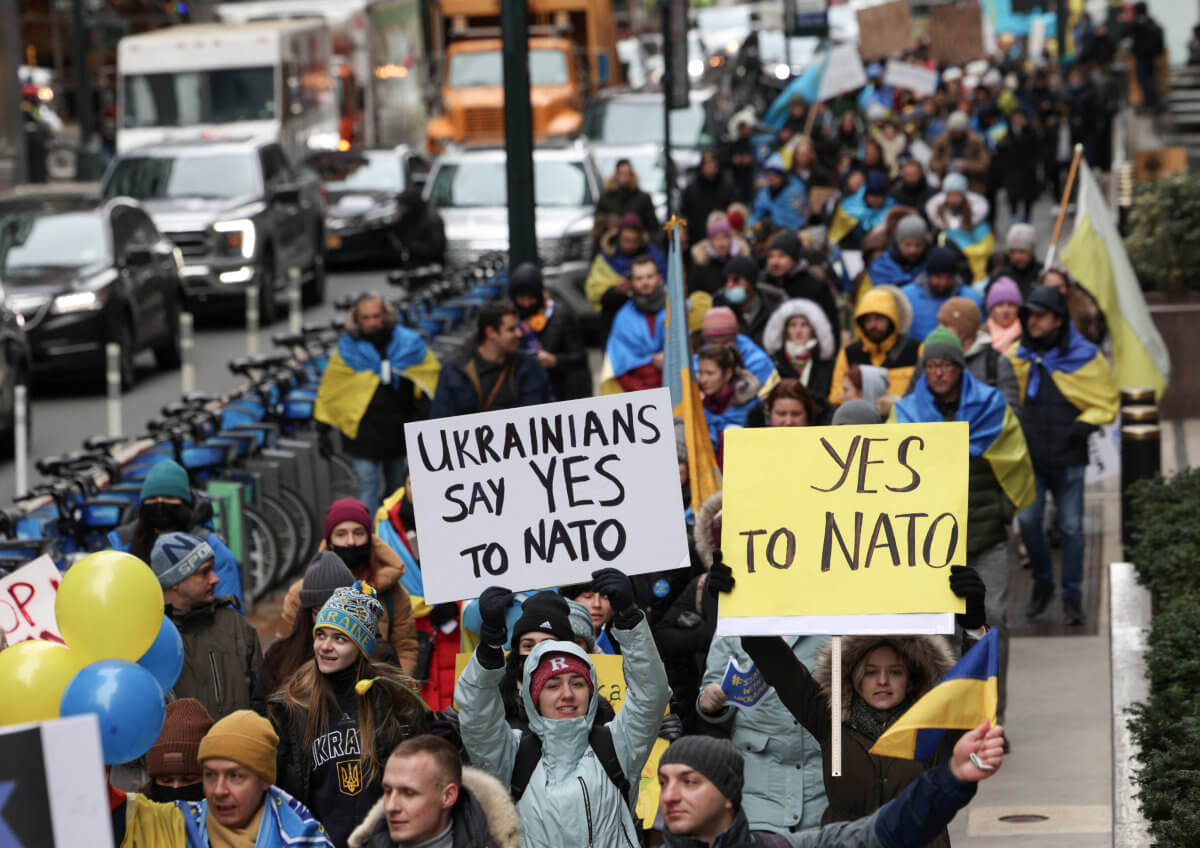 People take part in a protest after Russia launched a massive military operation against Ukraine, in New York City