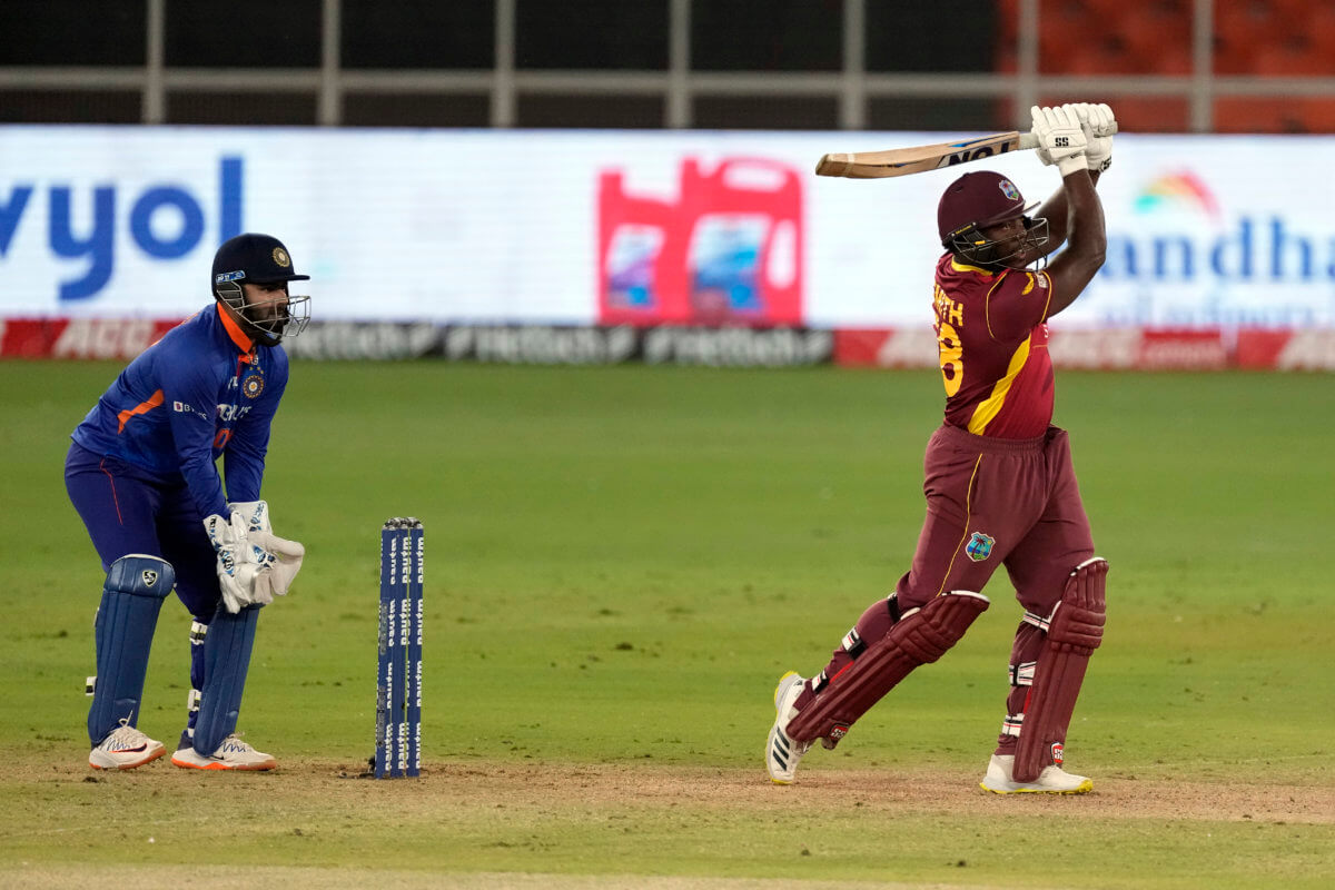 West Indies' Odean Smith, right, plays a shot during the third one day international cricket match between India and West Indies in Ahmedabad, India, Friday, Feb. 11, 2022.