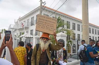People protest to demand an apology and slavery reparations during a visit to the former British colony by the Duke and Duchess of Cambridge, Prince William and Kate, in Kingston, Jamaica, Tuesday, March 22, 2022. The two-day visit to Jamaica is part of a larger trip to the Caribbean region encouraged by Queen Elizabeth II as some countries debate cutting ties with the monarchy like Barbados did late last year.