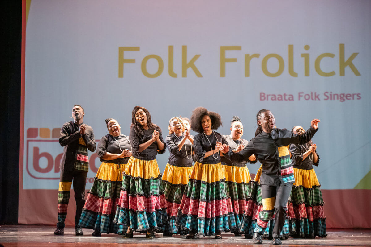 Jamaican born actor, singer, and producer Andrew Clarke leads Braata Folk Singers during one of their concerts.