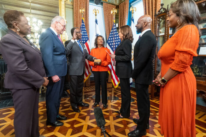 Vice President Kamala Harris administers the oath of office for U.S. Ambassador to Jamaica N. Nick Perry, Monday, May 9, 2022, in the Vice President’s Ceremonial Office in the Eisenhower Executive Office Building at the White House. The Ambassador’s wife Joyce Perry holds the family bible during the swearing-in. From left: Perry's sister, Pauline Perry; Sen. Charles "Chuck" Schumer; Amb. Nick Perry; Perry's wife, Joyce; Vice President Kamala Harris; the Perry's son, Nickolas, and daughter, Novalie. 