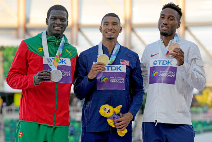 Gold medalist Michael Norman, of the United States, center, stands with silver medalist Kirani James, of Grenada, left, and bronze medalist Matthew Hudson-Smith, of Britain