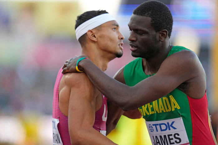 Gold medalist Michael Norman, of the United States, left, embraces Silver medalist Kirani James, of Grenada