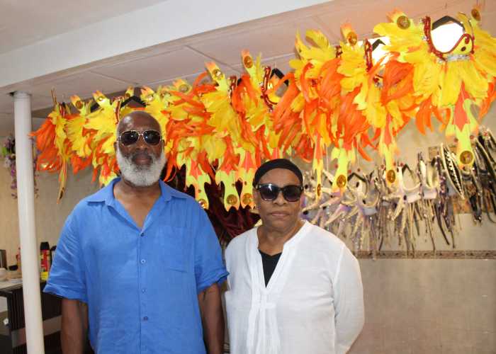 Mango Tree Production in conjunction with Deck Promotion, presents "Past, Present, Future," set for the Labor Day Carnival on Sept. 5. Derek Noel, (Deck Promotion) and costume designer/band leader Pauleen Loobie pictured against a colorful array of headpieces at the costume mas camp, 204 Parkside Ave., Brooklyn.