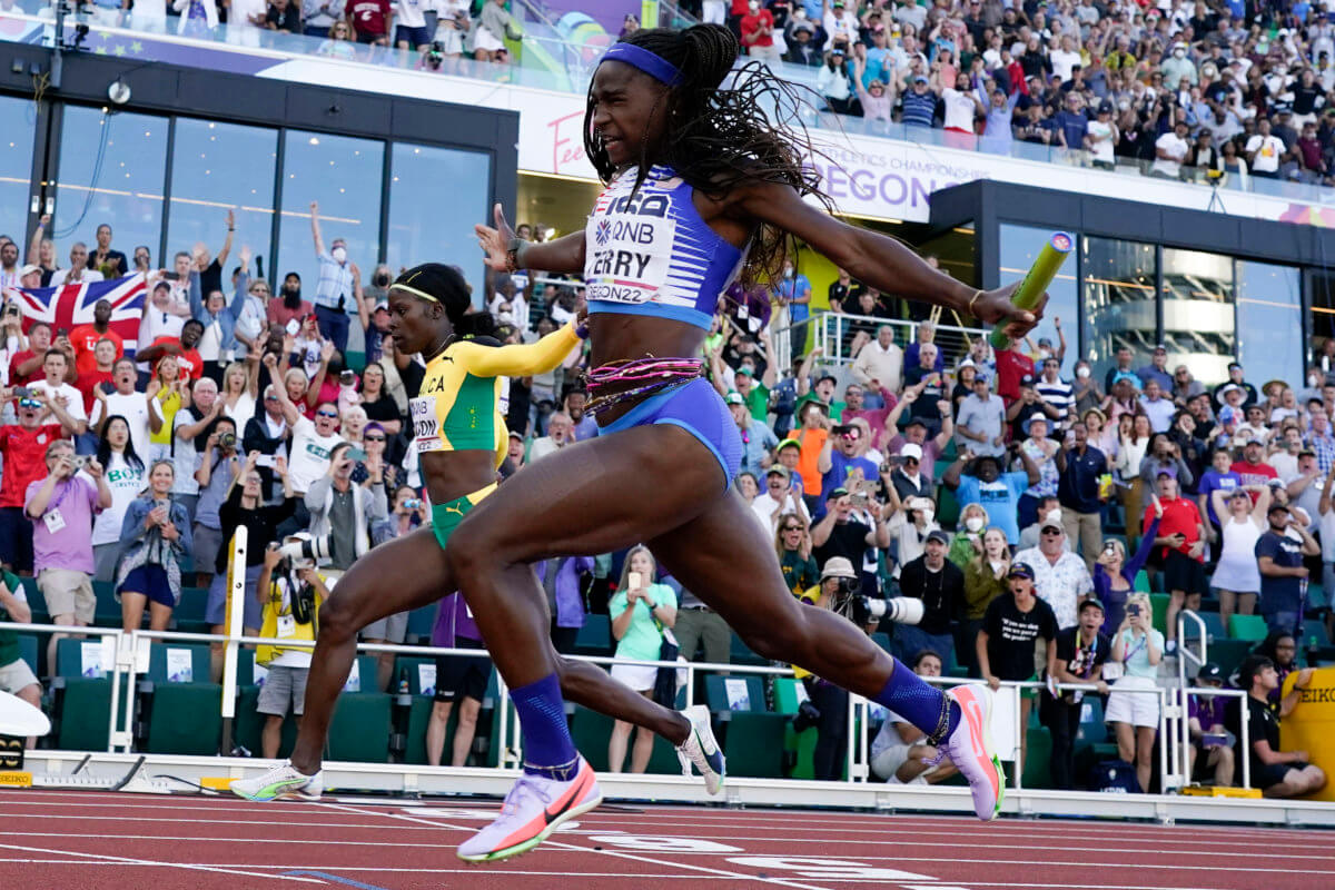 Twanisha Terry, of the United States, wins the final in the women's 4x100-meter relay as Shericka Jackson, of Jamaica,
