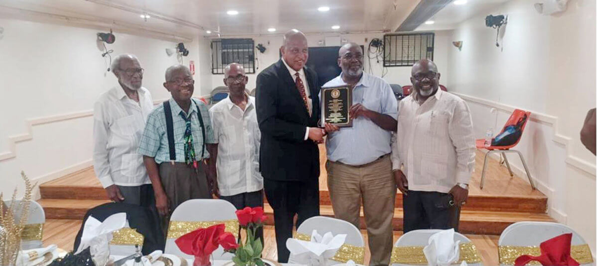 Outgoing St. Vincent and the Grenadines Consul General to the US Howie Prince receives plaque from Brooklyn Mechanics.