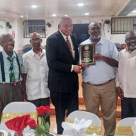 Outgoing St. Vincent and the Grenadines Consul General to the US Howie Prince receives plaque from Brooklyn Mechanics.