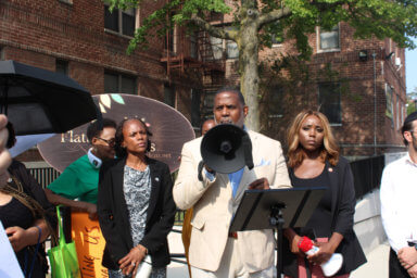 Assemblymember Monique Chandler-Waterman, NYS Sen. Kevin Parker, and Councilmember Farah N. Louis, surrounded by protesters, demanding change at Flatbush Gardens in Brooklyn.