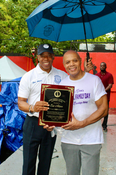 Mayor Eric L. Adams accepts the Lenny Green Family Day Sapphire Award at the Aug. 7 at the 17th Annual event at Von Herbert King Park, in Bedford Stuyvesant, where the politician applauded the radio host for the years-old celebration in the community, that also pays tribute to the late Mama Green.