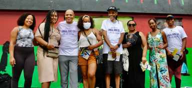 Family and honorees of the Mama Green Women of Dignity award presentation are pictured on stage at Von Herbert King Park. They are niece, Alizia Flores, honoree Jaja Blain, host of the Quiet Storm show on WLIB 105.7FM, Lenny Green, honoree Jennifer Murlak Ricketts, brother, Muata Green, honorees Josephine Longmire, Tayette Birch, and niece, Atika Green.