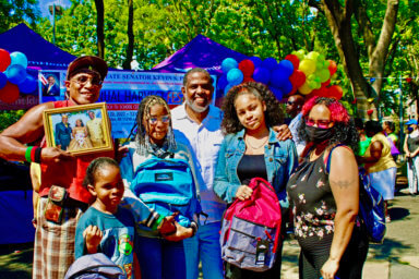 Sen. Kevin Parker (fourth from left), with recipients of backpacks at his 15th Annual Harvest Fest event in Brooklyn.