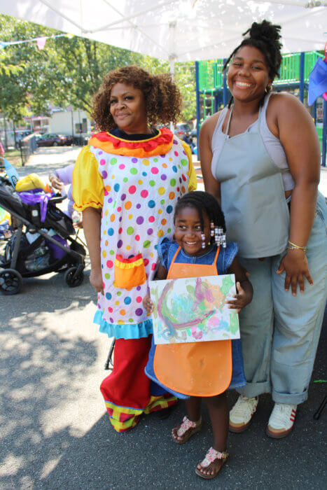 A happy little girl shows off her painting from the IG Natural Creature able at Sen. Kevin Parker's 15th Annual Harvest Fest.