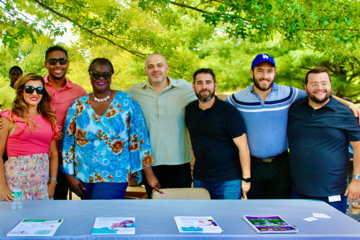 NYS Senator Roxanne J. Persaud (third from left), surrounded by the staff of Four Seasons Healtcare Solutions at the politician's annual fun day and back-to-school event in Canarsie Park.