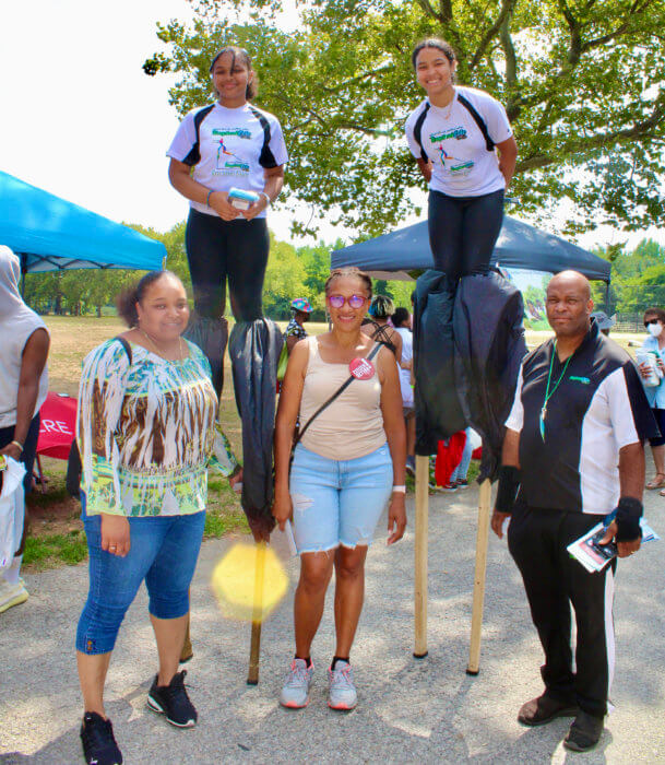 Tropical Fete stilt dancers show off their skills, with a parent left, supporter, Karen Wharton, and founder/creative director of Tropical Fete, Alton Aimable.