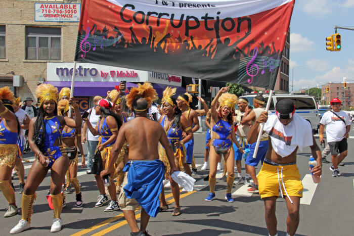 Masqueraders in T&T presents "Corruption" during the Queens Caribbean Carnival in Far Rockaway.